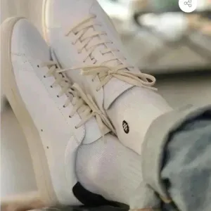 Clae white leather with navy sneakers, gently worn, size 10. Bradley essentials.