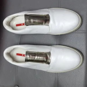 Prada White leather slip on, silver tongue shoes